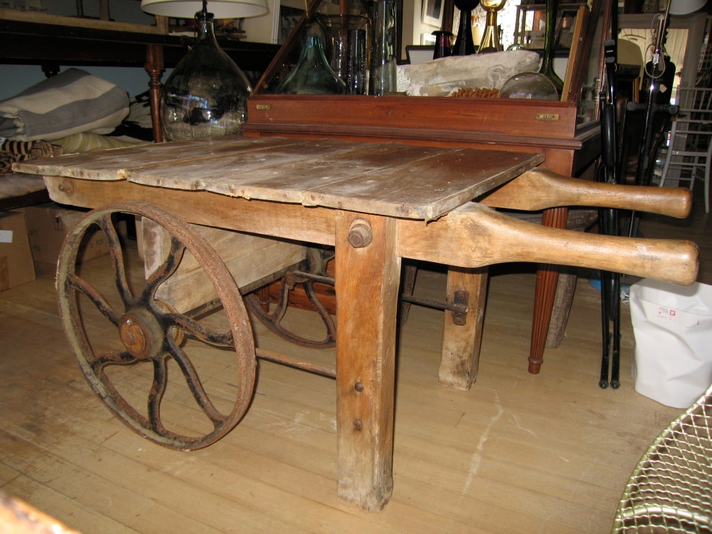 Great rustic cart with cast iron wheels and tapered worn handles makes a great side table