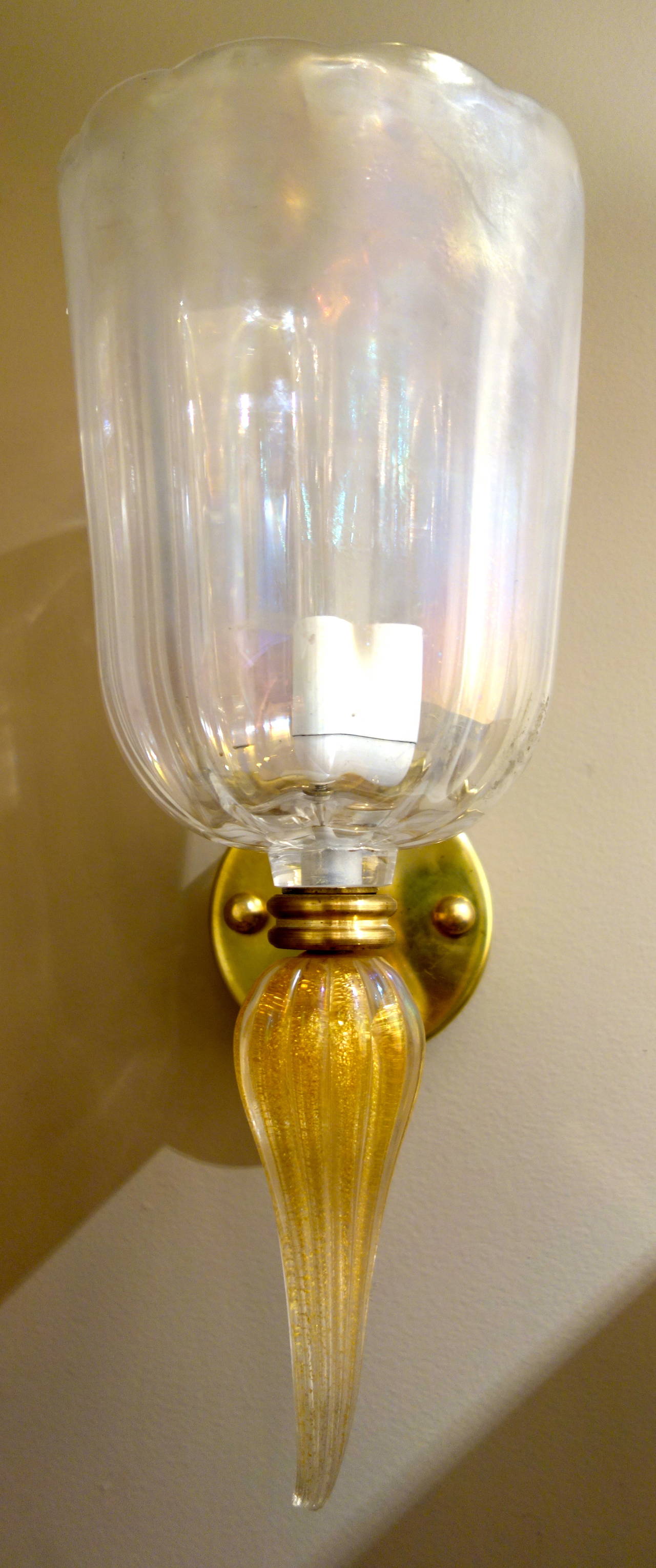 A pair of Mid-Century Italian heavy handblown Murano glass sconces by Seguso,  the upper portion tulip shaped in subtle opalescent glass, the bottom of teardrop form in fluted gold glass with brass hardware, single socket newly wired for the