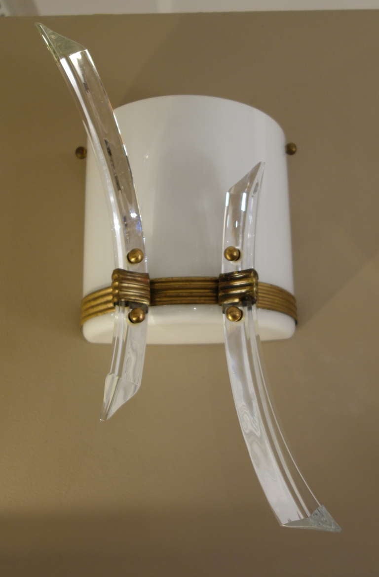 A pair of Mid-Century Italian Sconces with an opaque white half cylindrical body with two curved Murano glass rods screwed on to a brass ribbed band with two sockets newly wired for the American market.