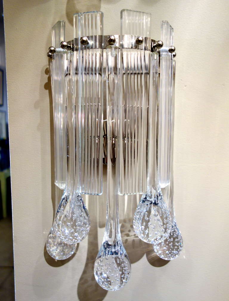 Two pairs of Italian Murano sconces attributed to Mazzega comprised of alternating flat, fluted glass rectangles with teardrop pendants on chrome,
frame with two sockets newly wired for the American market.