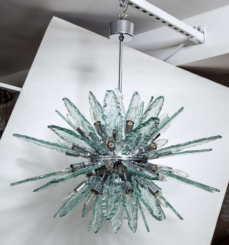Italian Fontana Arte style Sputnik chandelier comprised of six rows of flat, thick
jagged edge hand blown clear glass pieces that screw into a chrome frame, 34