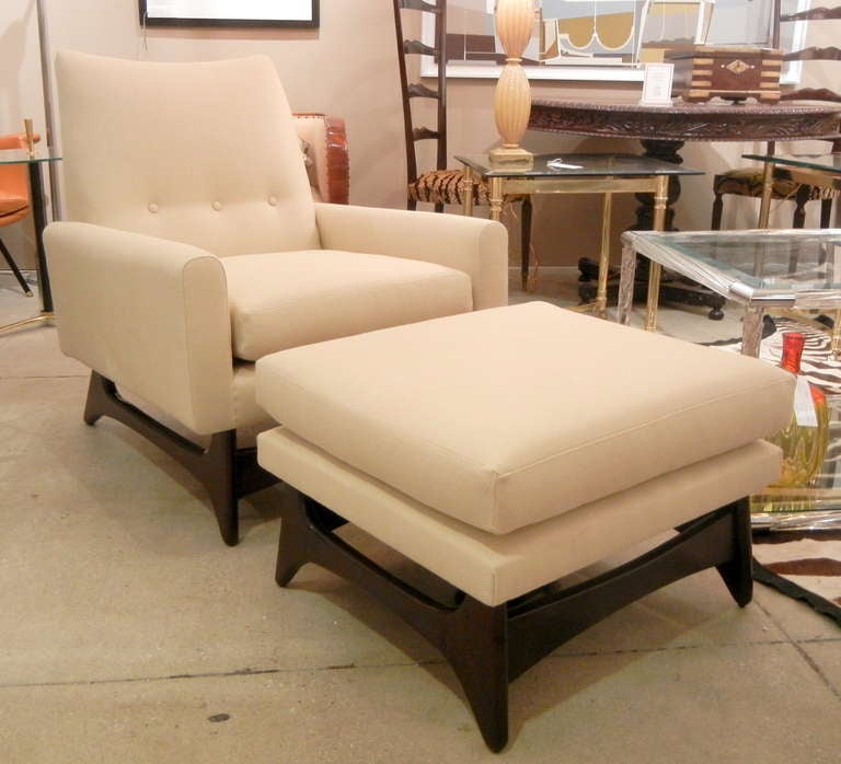 A large pair of Mid-Century Adrian Pearsall Club / Lounge Chairs
with two matching ottomans, the chairs with high shaped backs with
three buttons, the upright arms and loose seat cushions resting on floating wood bases
with a matching pair of