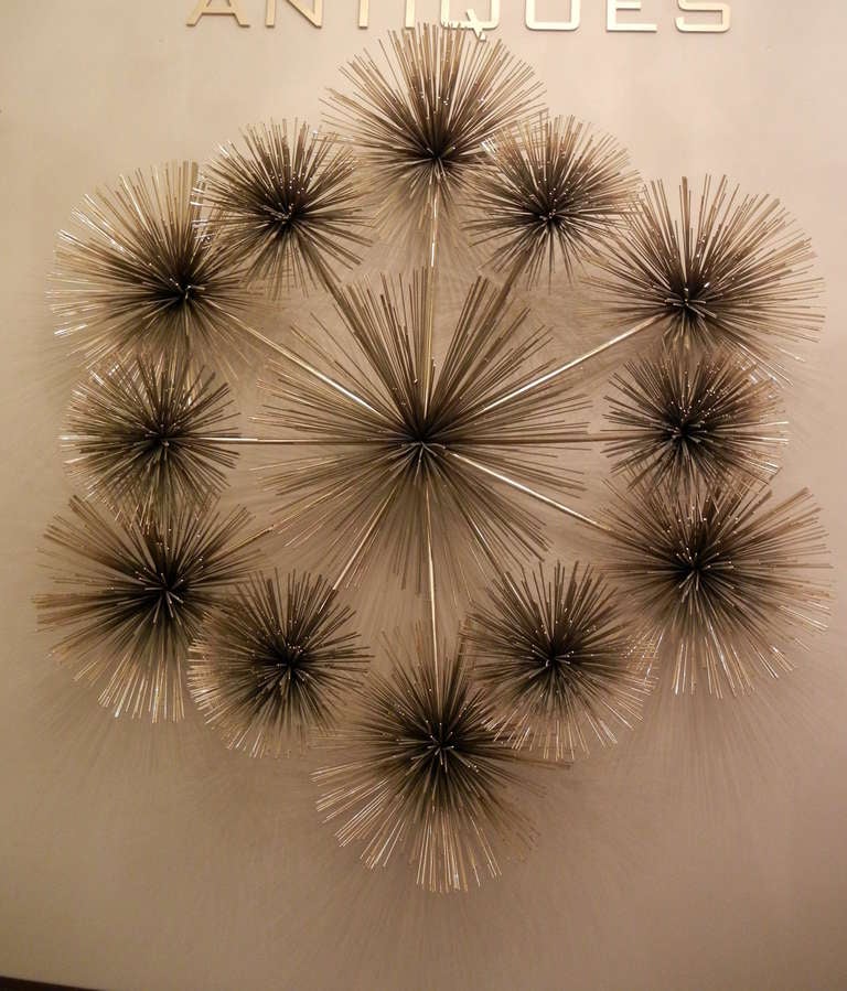 A Mid-Century Modern Curtis Jere brass wall sculpture featuring twelve 