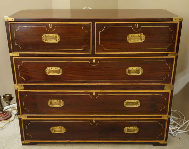 A 19th century Anglo-Indian rosewood two-part, brass bound campaign chest featuring two short drawers over three long ones, each trimmed with satinwood with original brass pulls and two side carrying handles on four block feet.