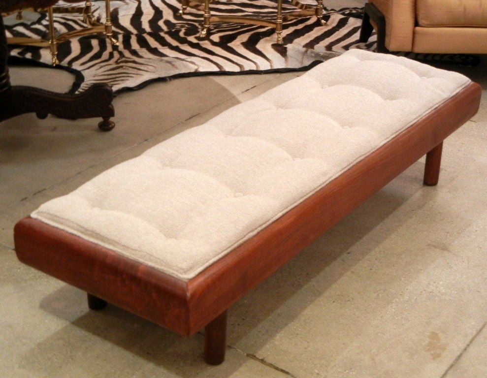An Adrian Pearsall Mid-Century 5' bench comprised of a thick walnut frame, the top portion with rounded edges resting on four cylindrical legs, newly upholstered in tufted pale gray boucle fabric.

Keywords search: long bench, coffee table, window