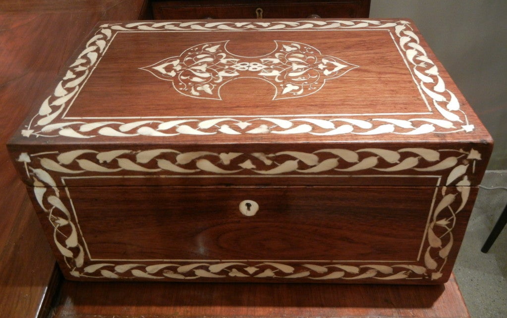 A large early 19th century teak wood fitted box from the Coromandel coast with a scrolling Regency design of bone inlay bordering all sides, the top adorned with a central oriental medallion.
 
