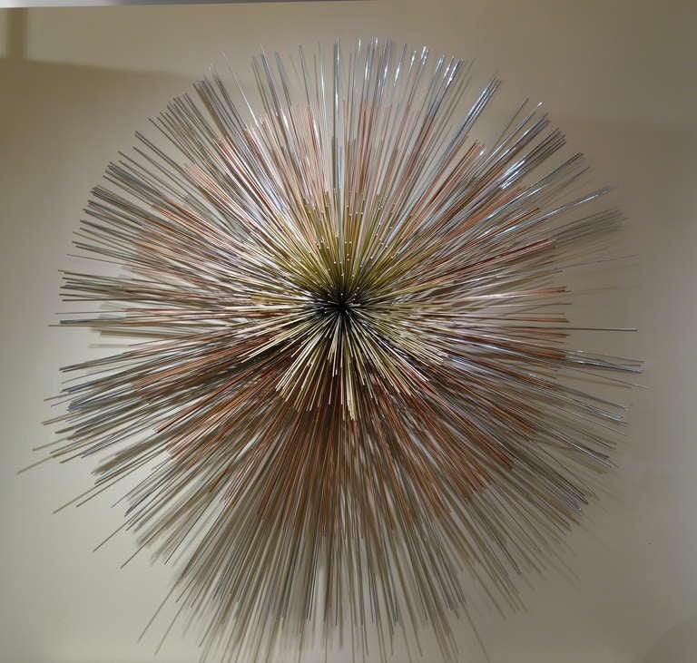 A Mid-Century Century signed Curtis Jere multi-toned metal wall
sculpture comprised of three concentric circles, the brass center protruding from two different lengths of this copper and steel rods.

Keywords Search: 1stdibs, 1stdibs.com, Artisan