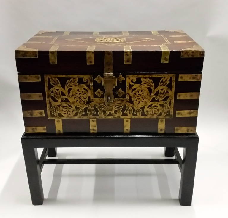 A large late 19th century Anglo-Indian two handled rosewood fitted box or side table with a profusion of brass inlay, the brass cornered top with a diamond and rectangular central medallion, the front with foliate design and brass strapping on each