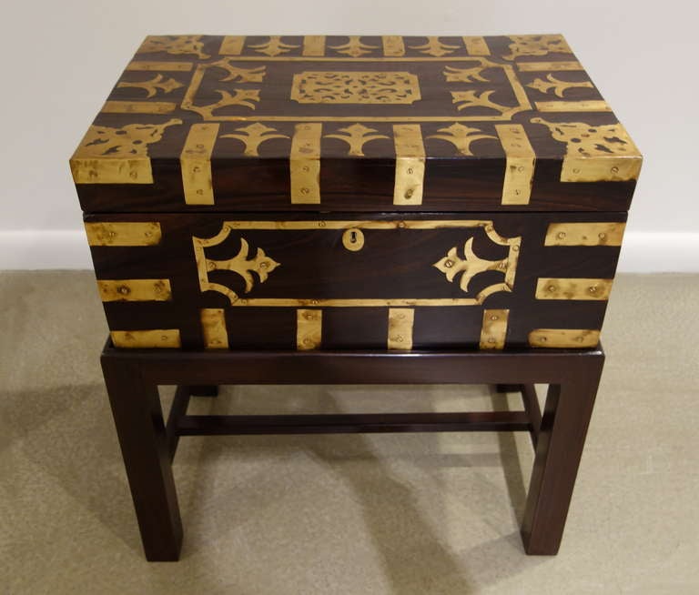 A late 19th century Rosewood campaign box inlaid with brass on each side with two brass handles, the interior divided into<br />
compartments with removable section on later rosewood<br />
custom stand.<br />
<br />
