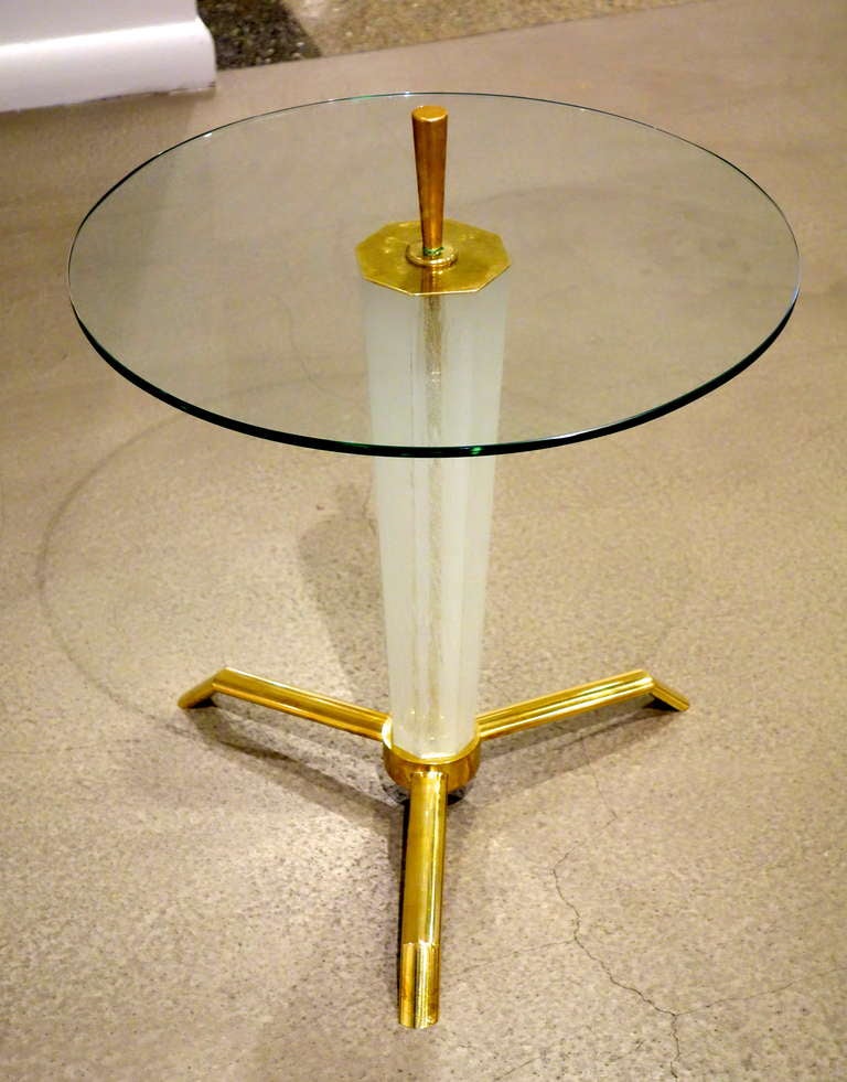 A Mid-Century Italian Side/End Table with circular
glass top pierced with a brass 3.5