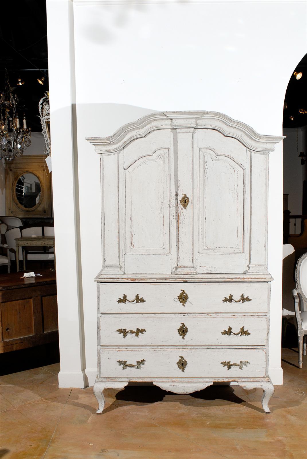 Painted 18th century Swedish linen press with upper cabinet over three drawers, circa 1760.
