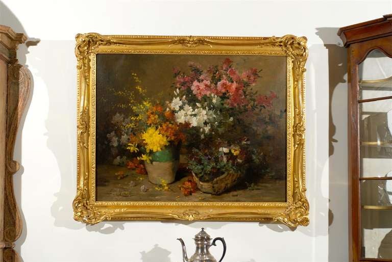 A French still-life floral painting from the third quarter of the 19th century by Louis-Émile Minet (1841-1923), set in a giltwood frame. This French still-life painting features an exquisite arrangement of bouquets of flowers depicted on a neutral