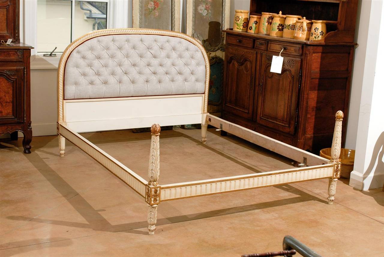 19th century painted French bed with upholstered and carved headboard, carved rails and footboard.