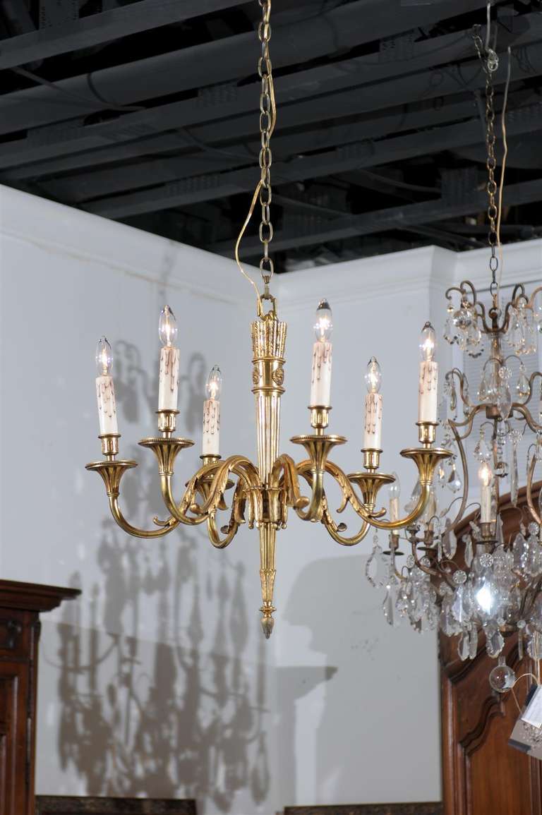 A French rare gilt bronze Louis XVI style six-light chandelier with quiver and arrows motif from the late 19th century. This French gilt bronze chandelier features an exquisite central shaft, shaped in the form of a quiver with arrows. The upper