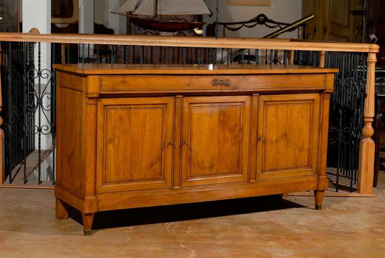 eEarly 19th century cherry directoire enfilade with three doors and two drawers.