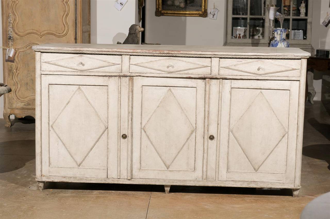 Swedish 19th century painted Gustavian enfilade with three drawers over three doors.