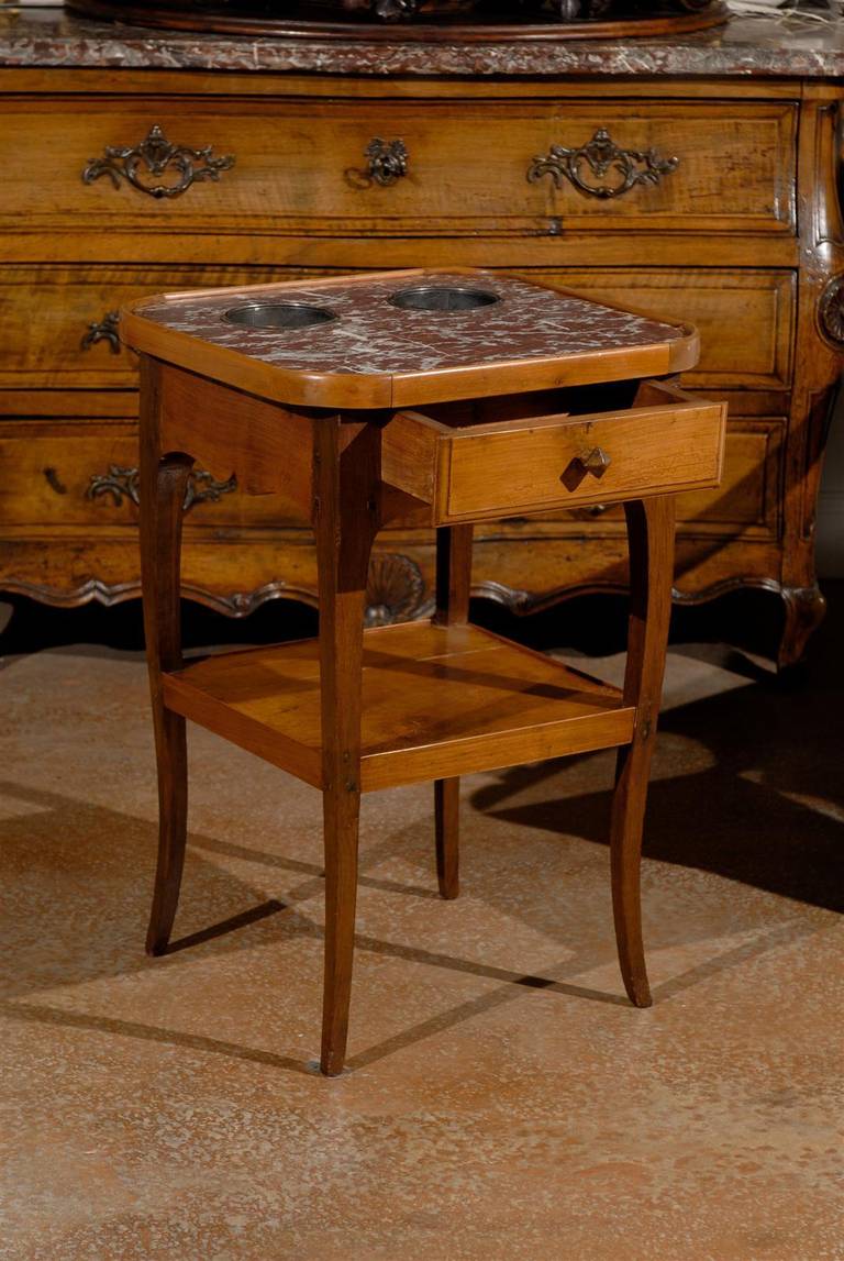 A French Louis XV style cherry rafraîchissoir side table with royal rouge marble top inset, coolers, single drawer and lower shelf from the mid 19th century. Born in the years that saw the birth of the Second Empire, this French rafraîchaissoir