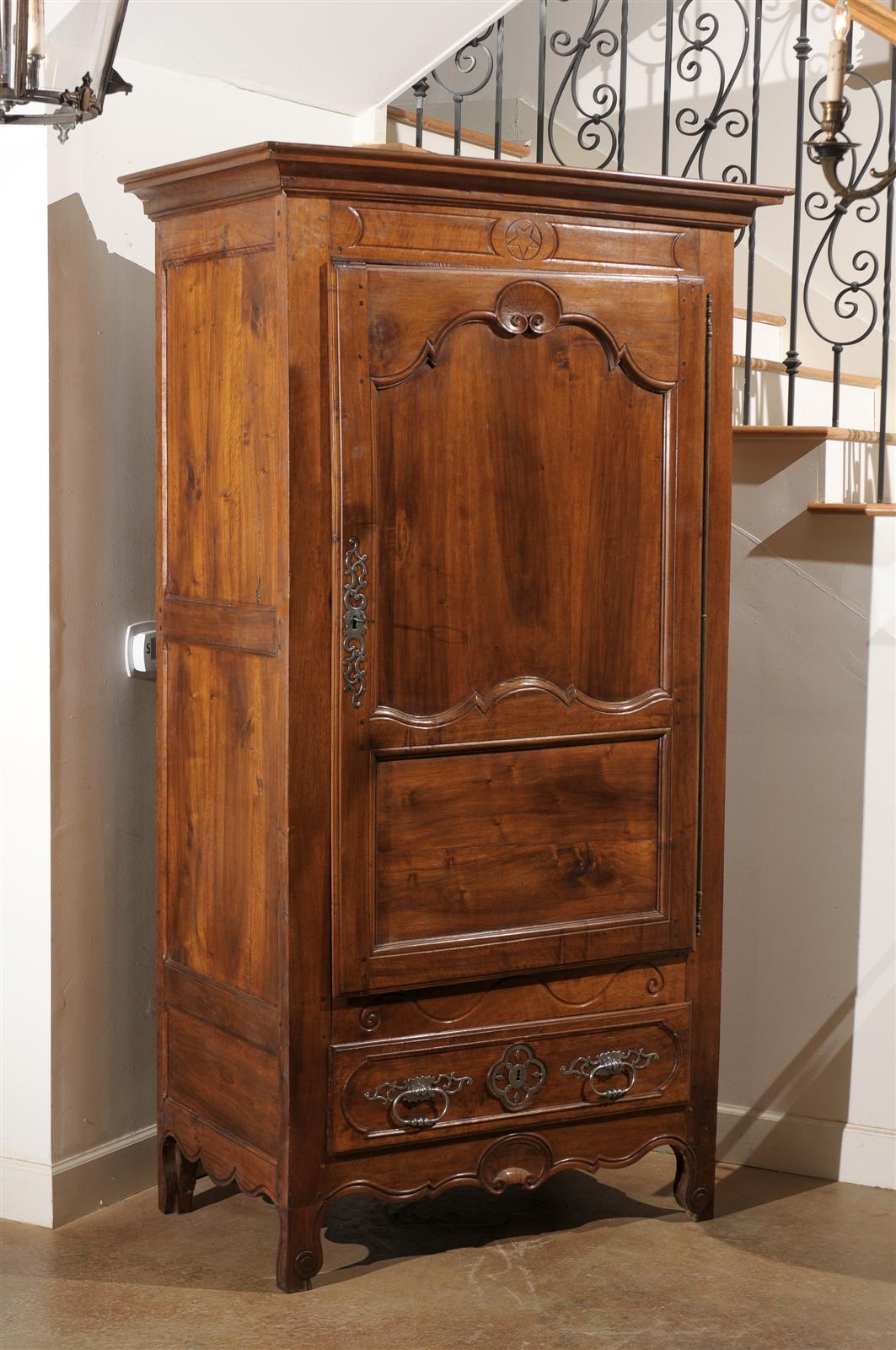 French 18th century walnut bonnetier with elegant carving, original hand-forged hardware and unusual lower drawer. Beautiful patina, circa 1790.