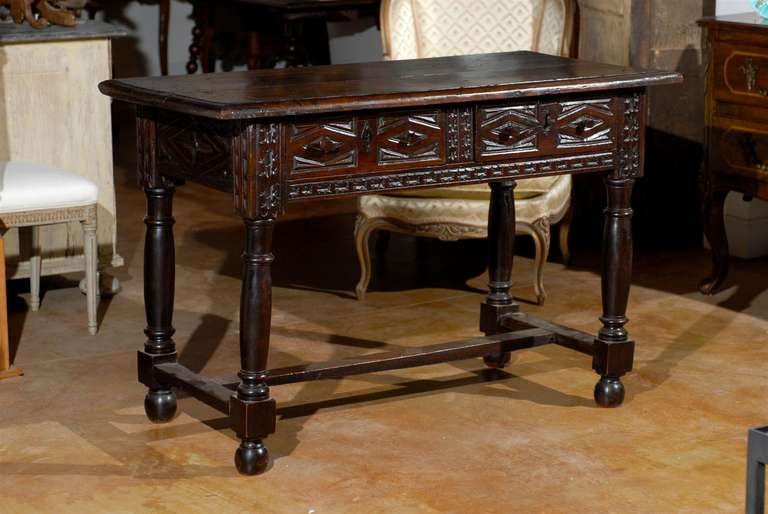 A mid-18th century Spanish Renaissance style dark walnut sofa table with two carved drawers, turned legs and cross stretcher. Born in Spain during the 1750s, this Renaissance style table features a rectangular top with rounded edges, sitting above