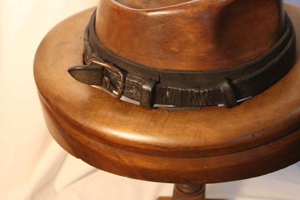 Vintage Milliner's Hat Block (Trilby) in polished hardwood with leather belt decorative trim.  On removable stand (unscrews from base).