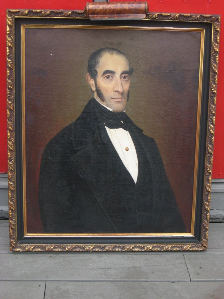 19th century American portrait of a gentleman in a wood frame.