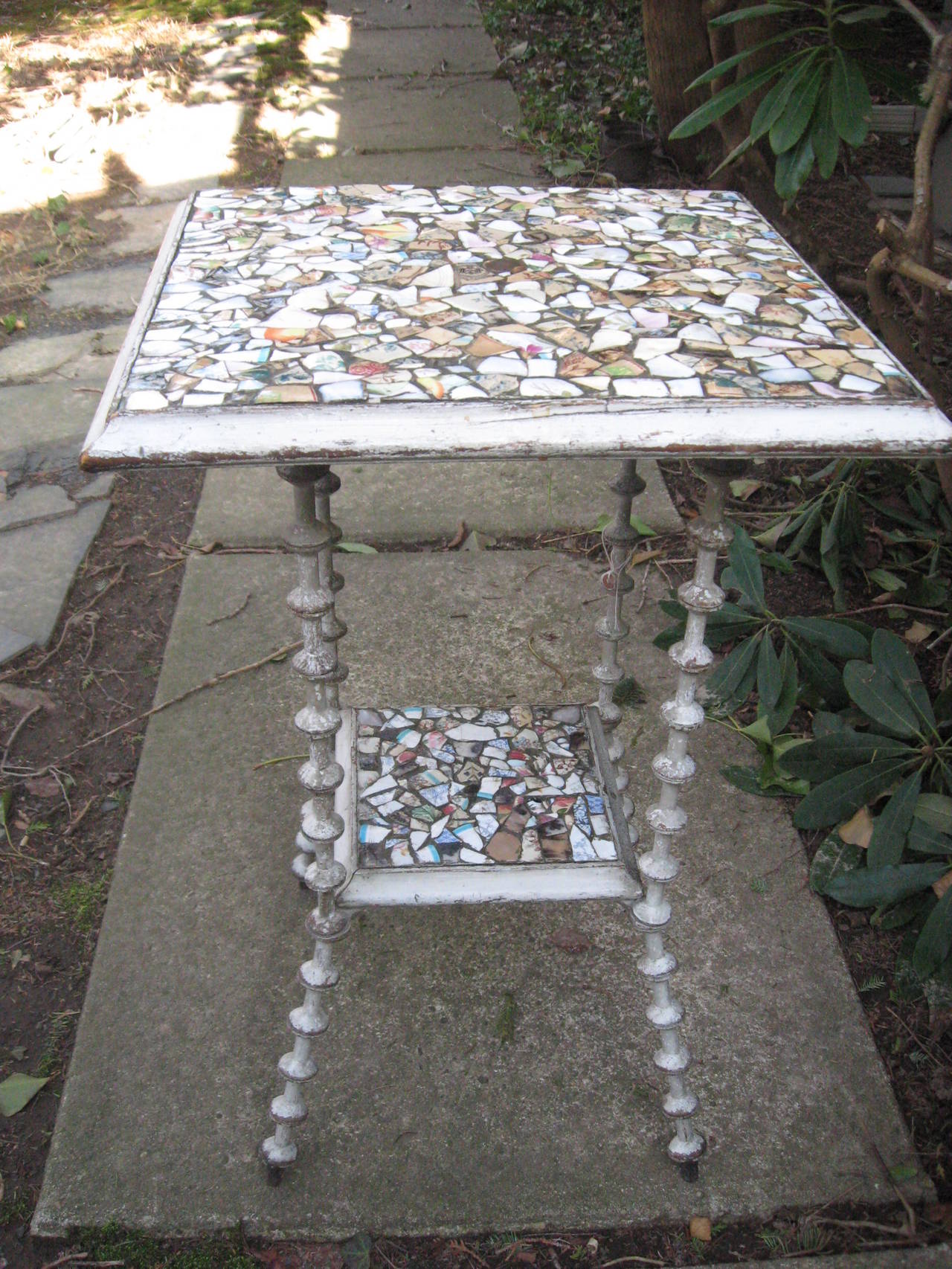 Great 19th century mosaic American two-tier tramp art spool table with antique dish pieces.