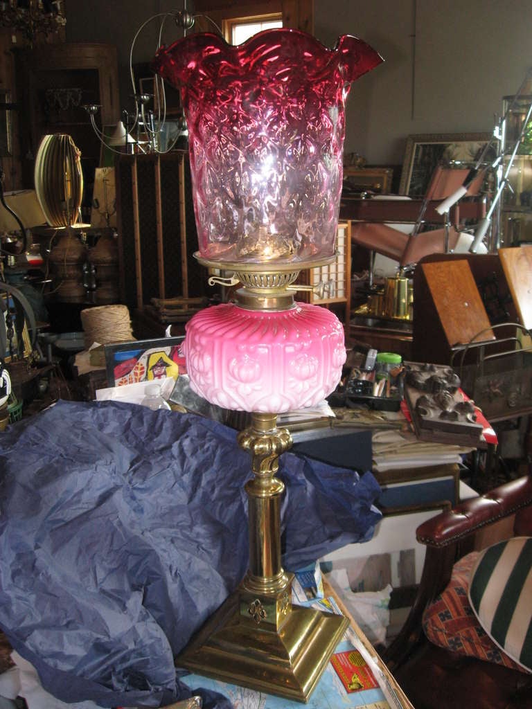 19th century American cranberry glass and brass oil lamp.