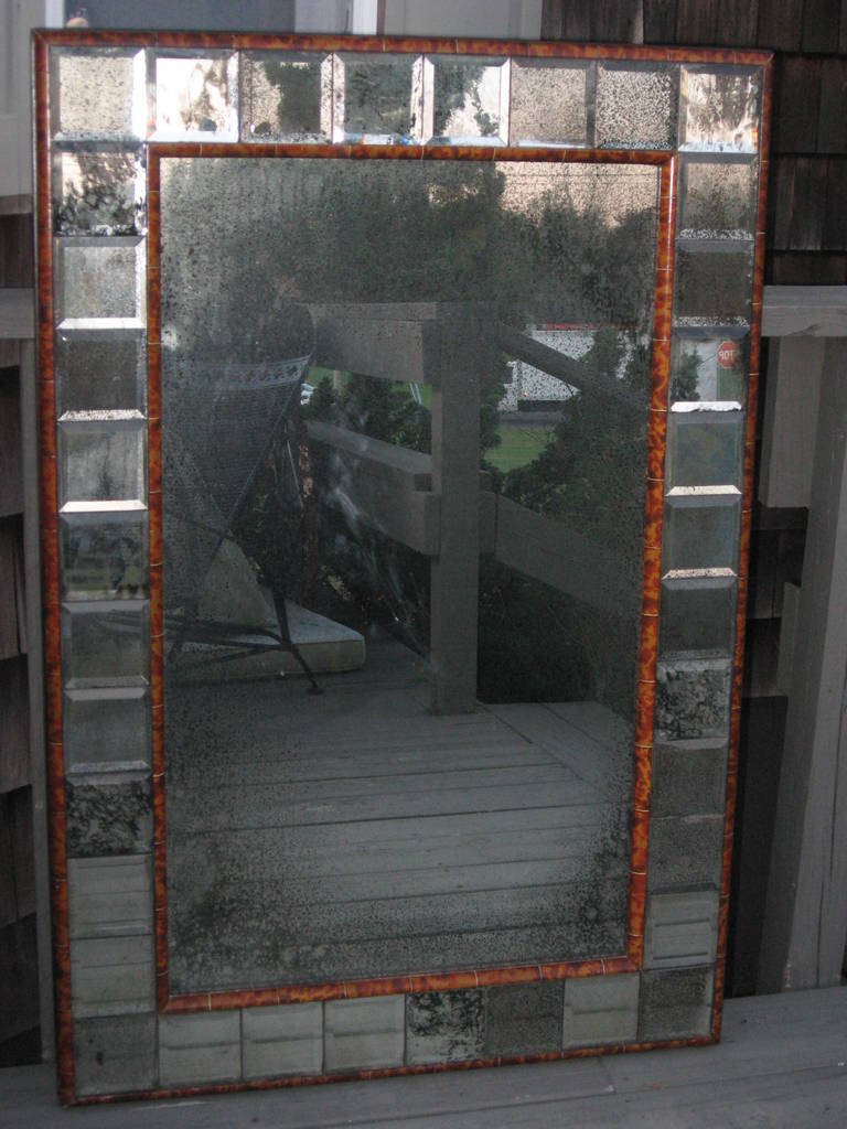 Faux tortoise shell mirror in a black lacquered wood frame with beveled.
Antiqued squares mirrored edge.