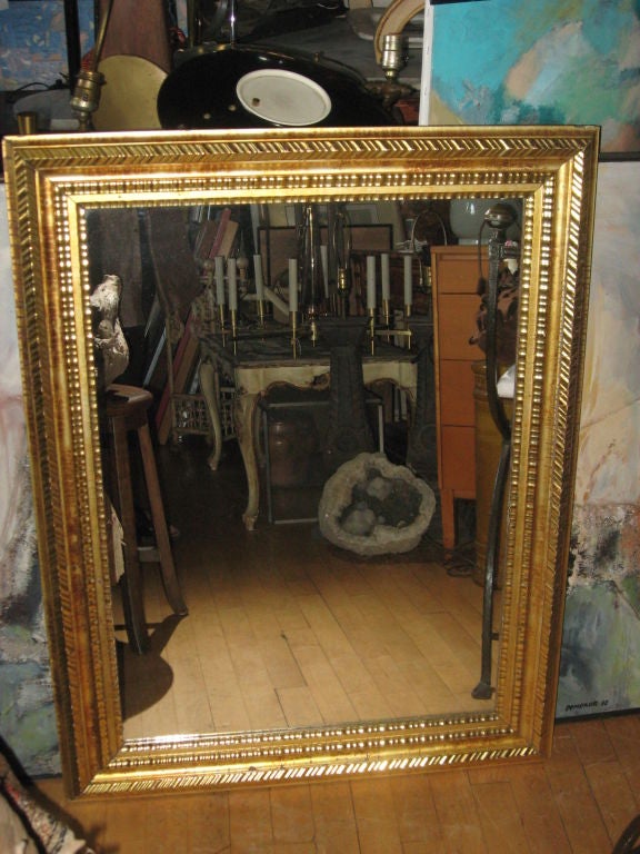 Antique giltwood frame with a later mirror.