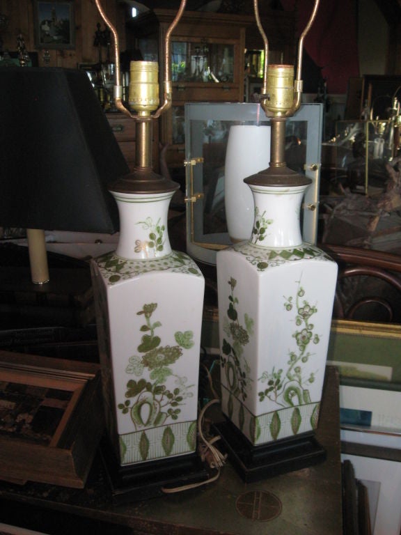 Pair of hand-painted oriental vases made into lamps in greens and gold on wooden bases.