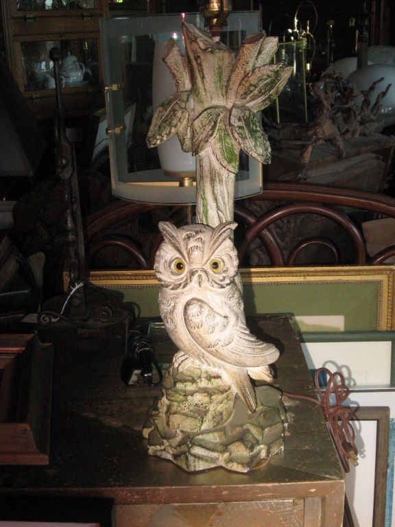 Hand-carved and painted wooden lamp with glass eyes.