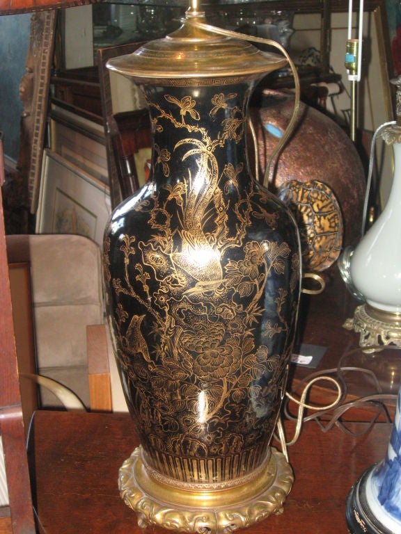 Oriental hand-painted gilt porcalain vase made into lamp on a oriental bronze base.