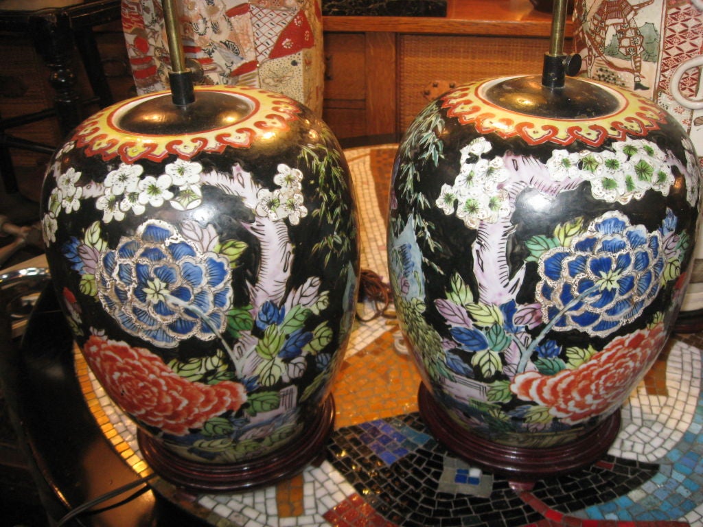 Pair of hand-painted oriental ginger jars made into lamps on wood bases.
