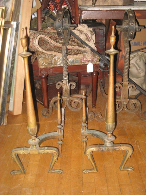 Pair of neoclassical style brass andirons with lions feet.