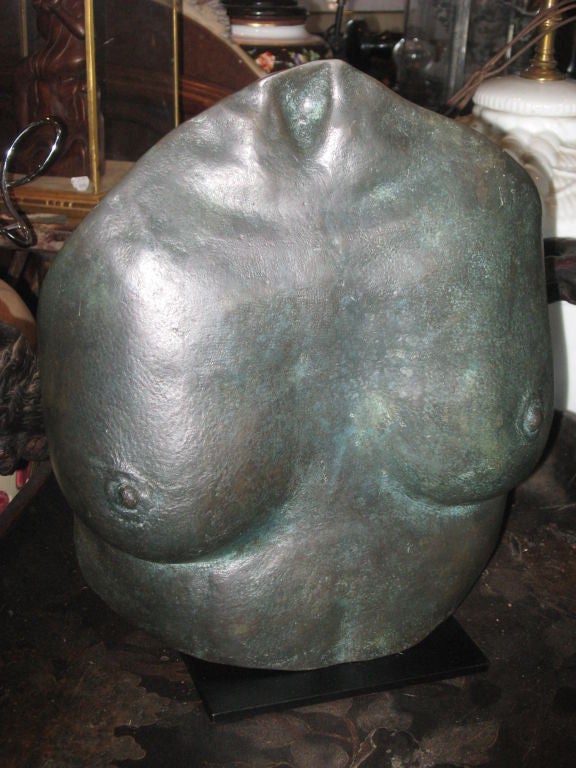 Bronze sculpture of torso by listed artist K. Braine on a handmade iron stand with green patina.