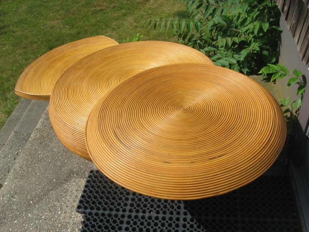 Vintage reed bamboo expandable coffee table that swings out on top and slides out on the bottom in the style
of Crespi.