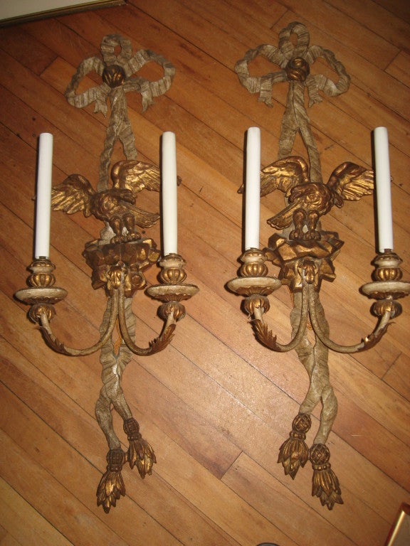 Mid-Century pair of Italian carved gilded wood and tin sconces with eagles. Wired.