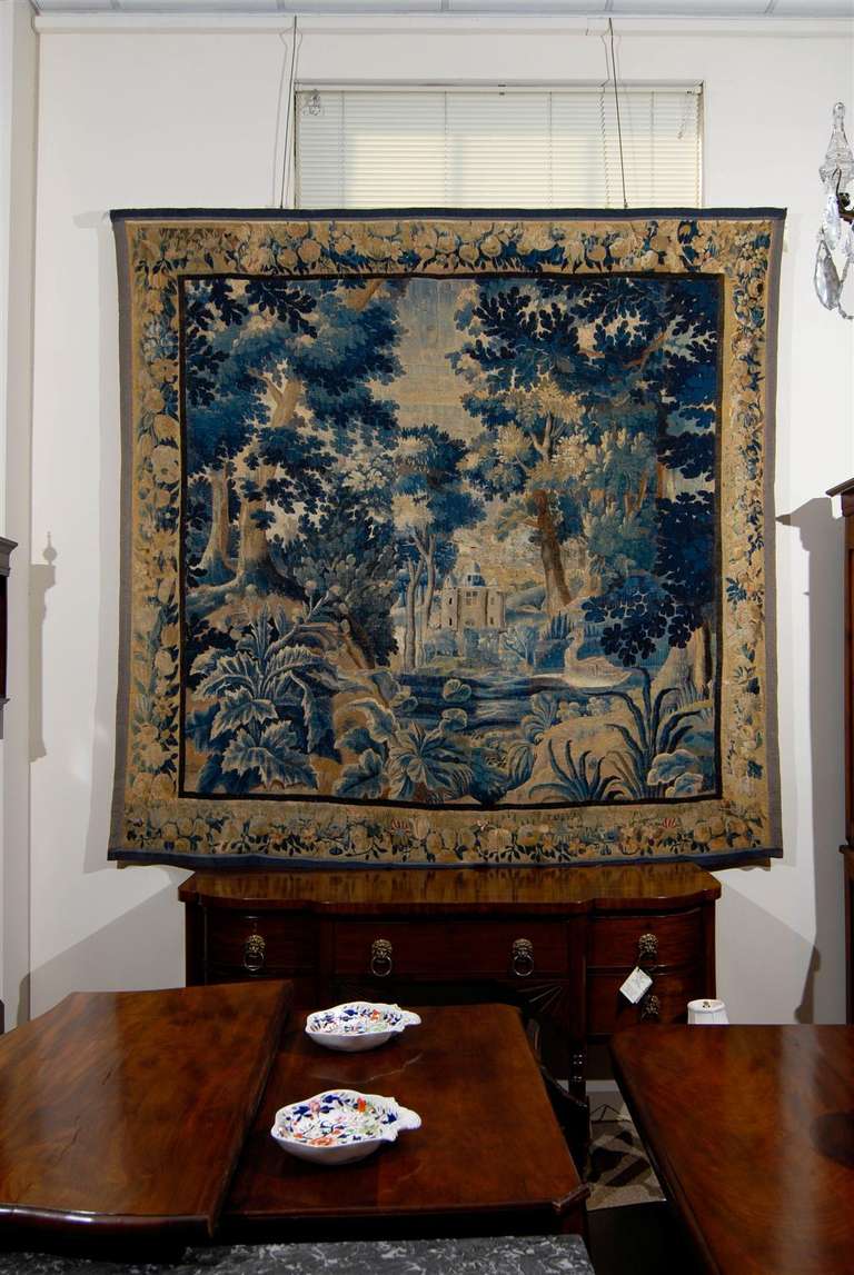 An Aubusson Tapestry depicting a castle in green landscape with boarder of foliage and fruit. The tapestry in green and blue hues. 

William Word Fine Antiques: Atlanta's source for antique interiors since 1956.