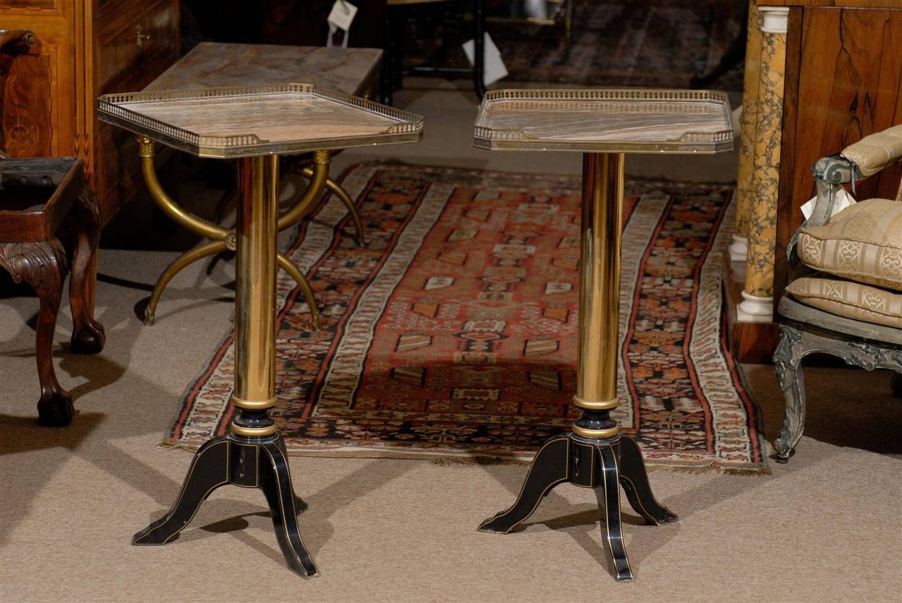 A pair of French side tables with marble tops, brass galleries, brass and painted tripod bases. 

William Word Fine Antiques: Atlanta's source for antique interiors since 1956.