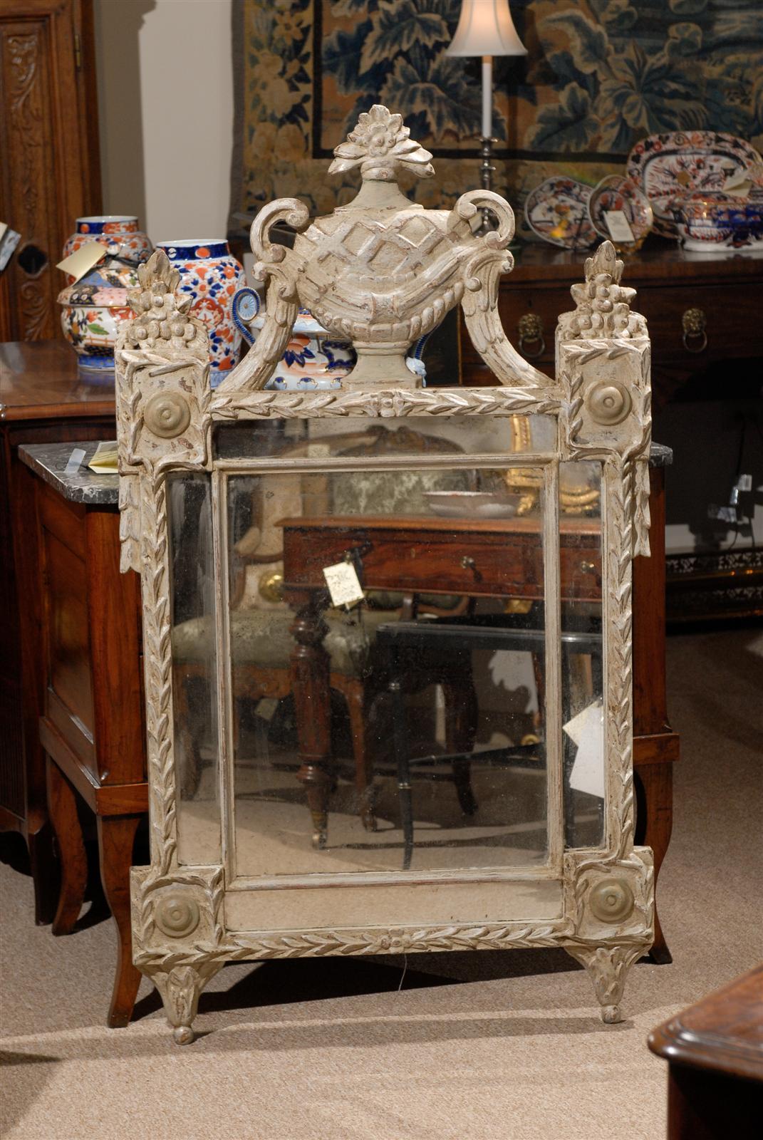 Neoclassical Italian mirror with painted finish and urn crest. 

William Word Antiques: Atlanta's source antique interiors since 1956.