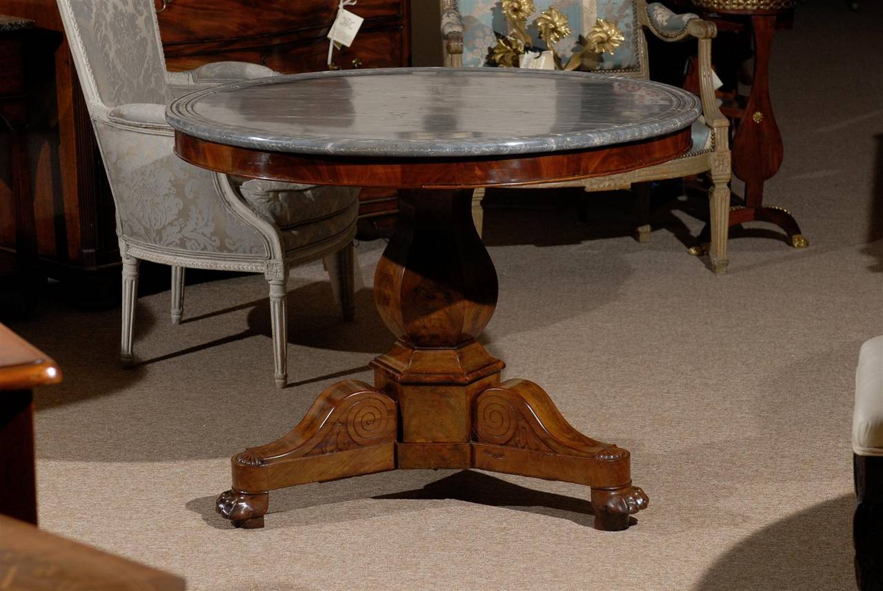 A French Restoration period mahogany center table with grey marble top. 

William Word Fine Antiques: Atlanta's source for antique interiors since 1956.