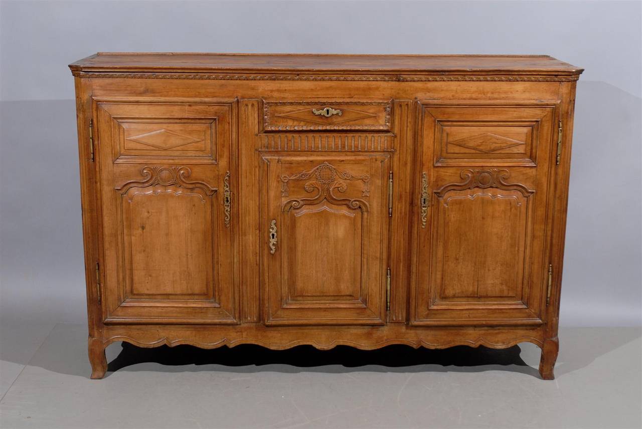 A French Louis XVI style fruitwood enfilade with three doors, one drawer, fluting and diamond detail and shaped apron.

William Word Fine Antiques: Atlanta's source for antique interiors since 1956.
