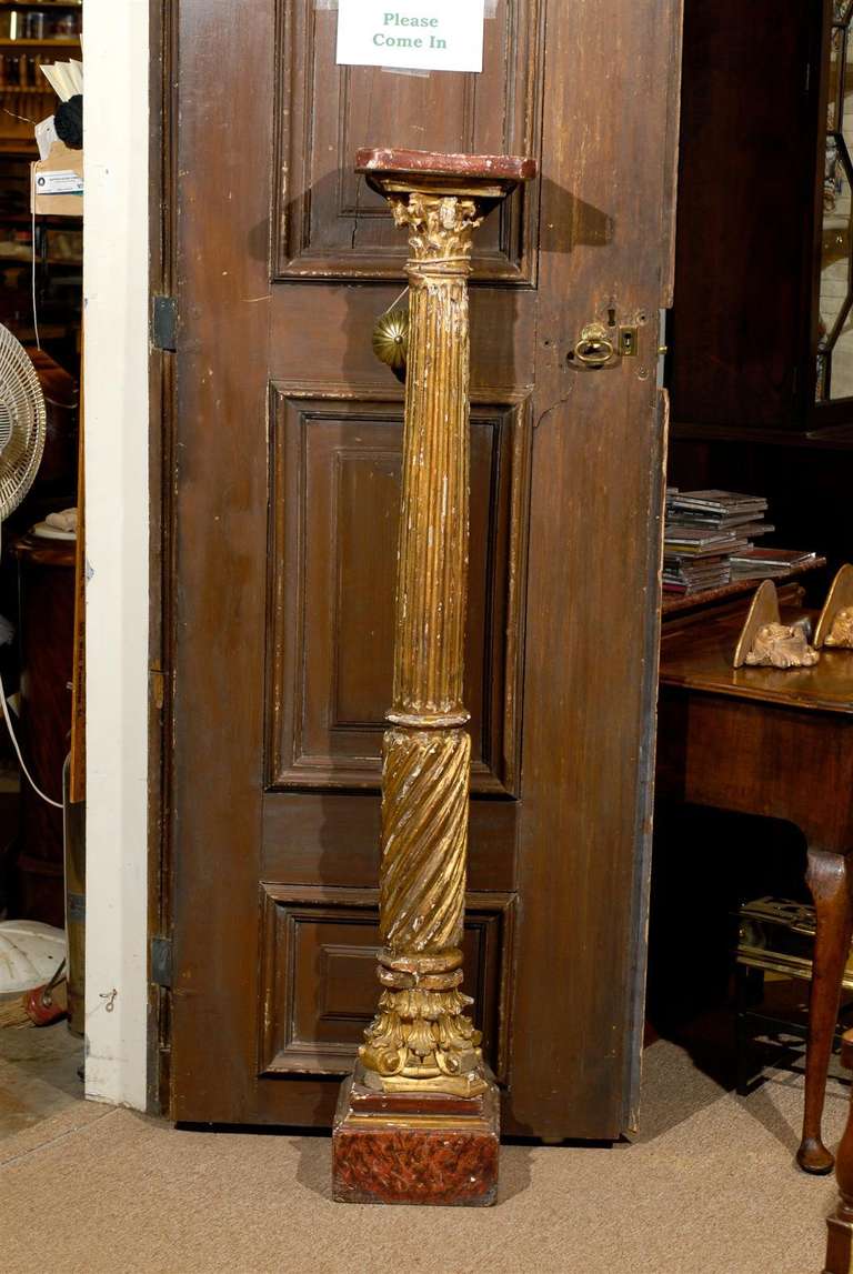 A pair of Neoclassical gilt-wood columns with painted top and base. 

William Word Fine Antiques: Atlanta's source for antique interiors since 1956.