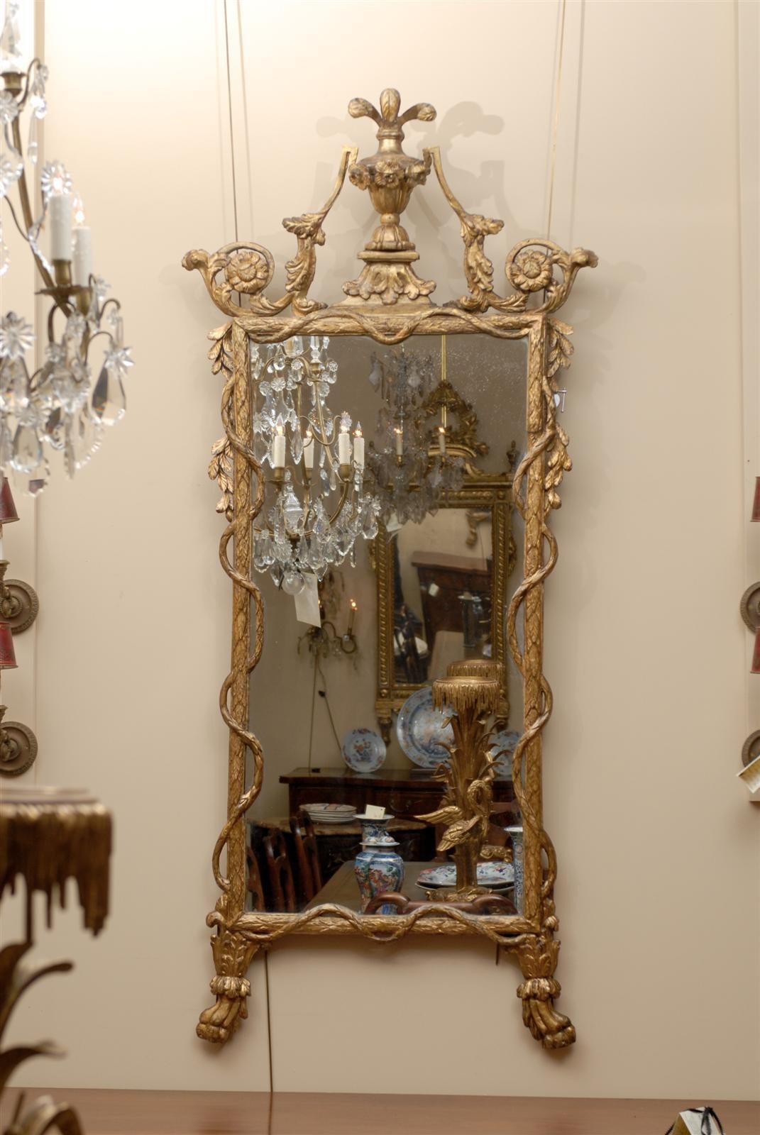 An Italian neoclassical giltwood mirror with feather plum crest, twisted vine detail and paw feet. 

William Word Fine Antiques: Atlanta's source for antique interiors since 1956.