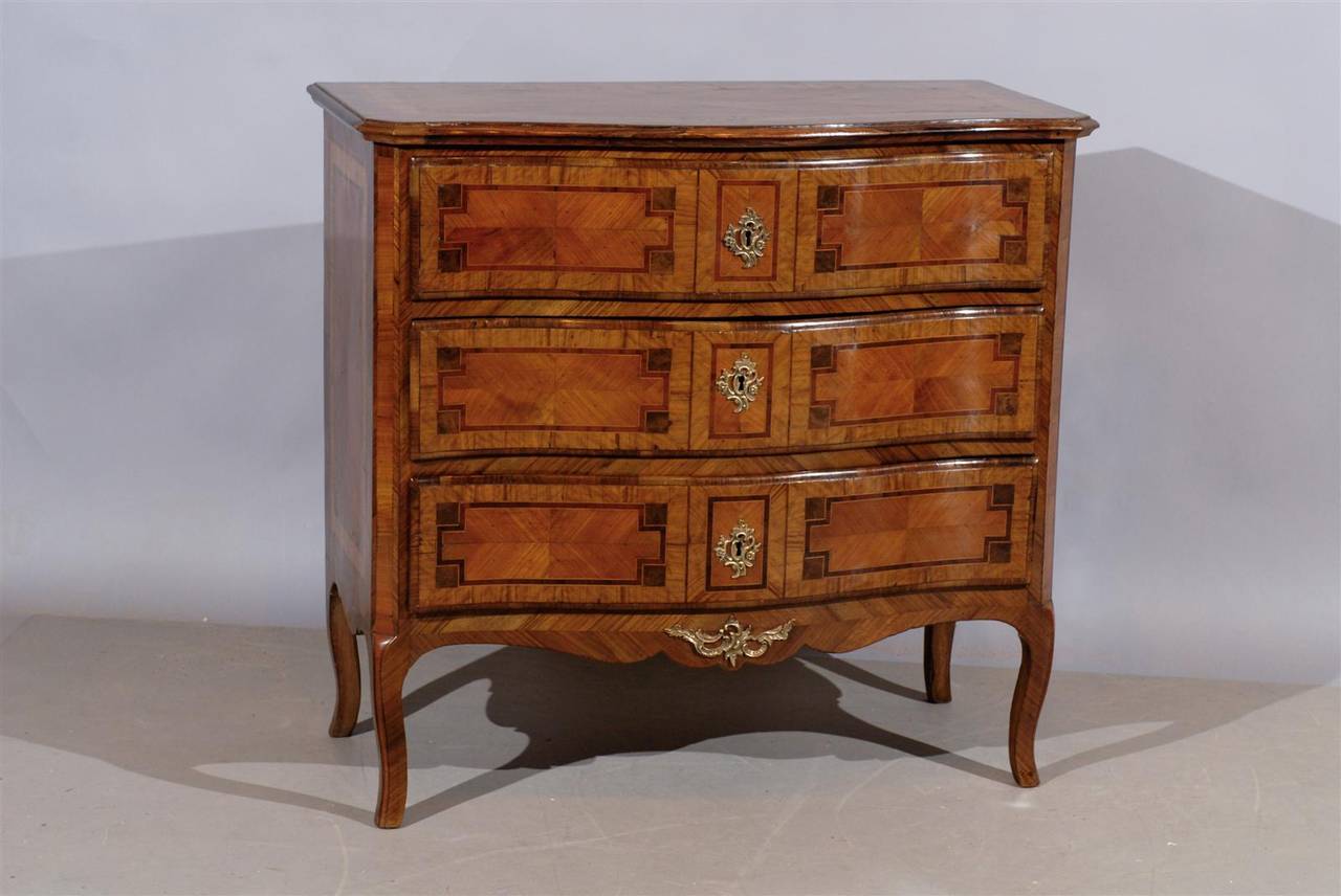 An Italian neoclassical inlaid commode in walnut, tulip and boxwood with serpentine front, three drawers, bronze doré mounts and shaped apron. 

William Word Fine Antiques: Atlanta's source for antique interiors since 1956.
