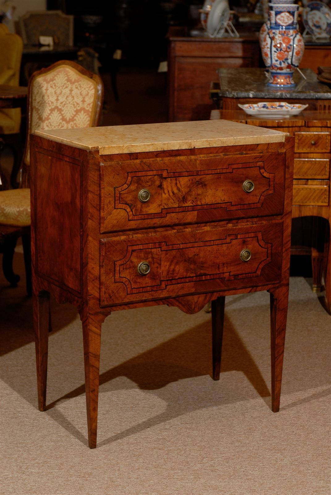 Petite neoclassical style Italian inlaid walnut commode with marble top and two drawers. 

William Word Fine Antiques: Atlanta's source for antique interiors since 1956.