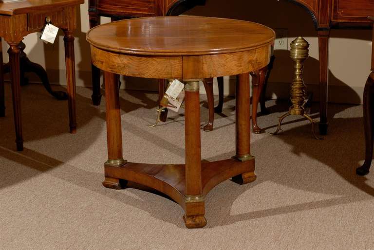 An Empire French Gueridon in walnut with bronze Detail and column legs with stretcher below. 

William Word Fine Antiques: Atlanta's source for antique interiors since 1956.