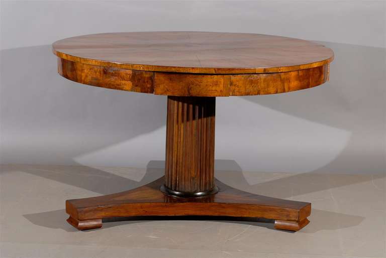 A walnut center table with 4 drawers and pedestal fluted base

William Word Fine Antiques: Atlanta's source for antique interiors since 1956.