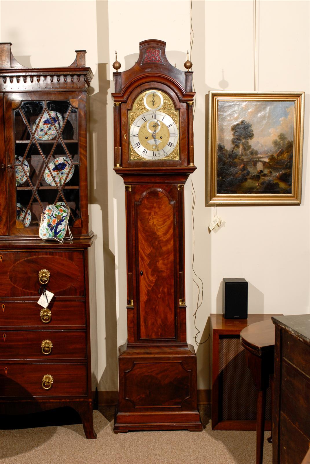 18th century English mahogany tall case clock with brass finials and column detail, brass and steel face signed 
