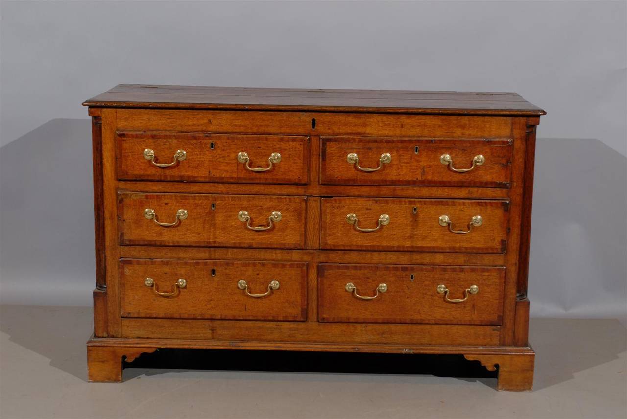 19th century English oak mule chest or blanket chest with reeded column corners and bracket feet. Originally had lift top for blanket storage, now with converted drawers for functionality.

William Word Fine Antiques: Atlanta's source for antique